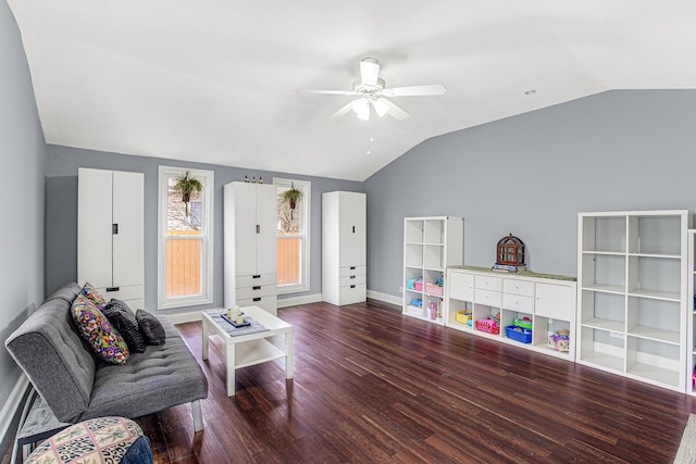 living room featuring vaulted ceiling, ceiling fan, and dark hardwood / wood-style flooring