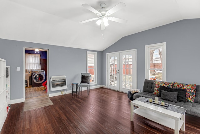 living room featuring heating unit, washer / dryer, dark wood-type flooring, and lofted ceiling