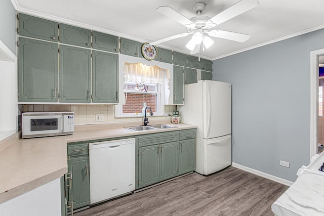 kitchen featuring green cabinetry, sink, white appliances, and light hardwood / wood-style floors