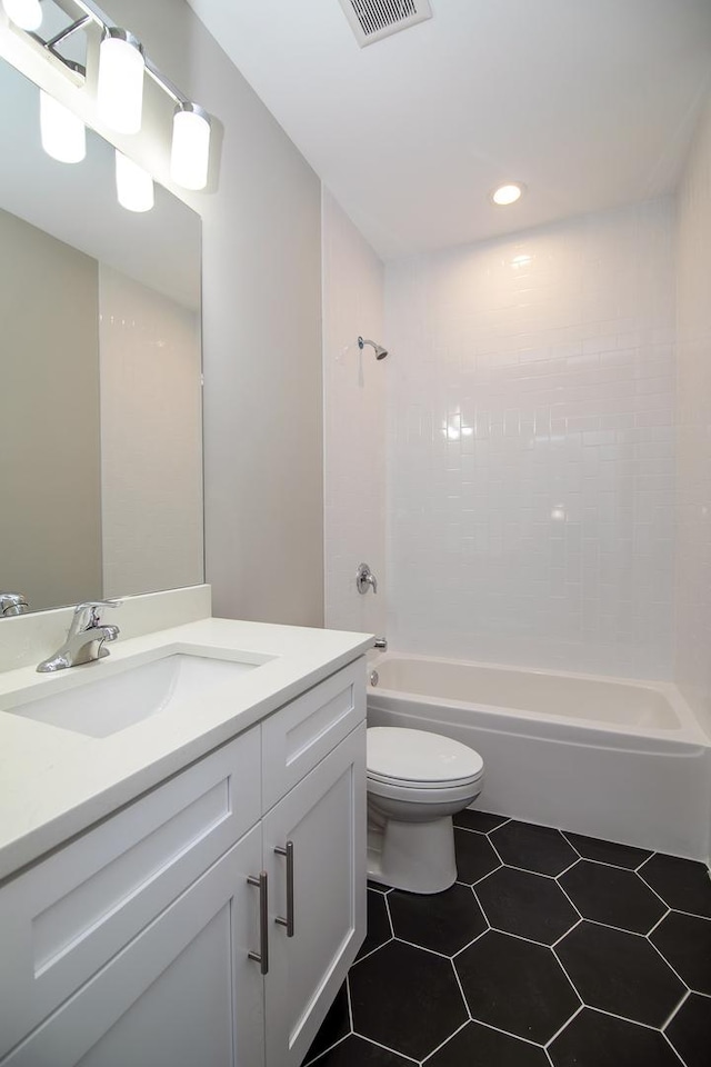 full bathroom with vanity, tile patterned floors, toilet, and washtub / shower combination