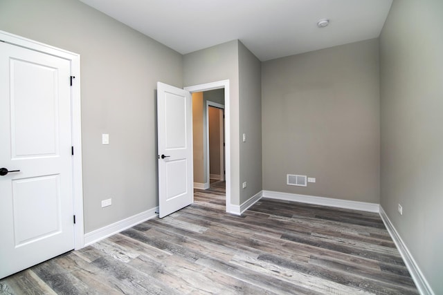 unfurnished bedroom with wood-type flooring