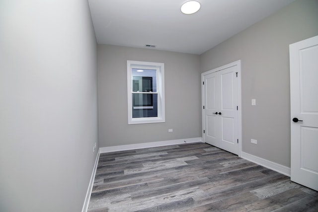 spare room featuring dark hardwood / wood-style flooring