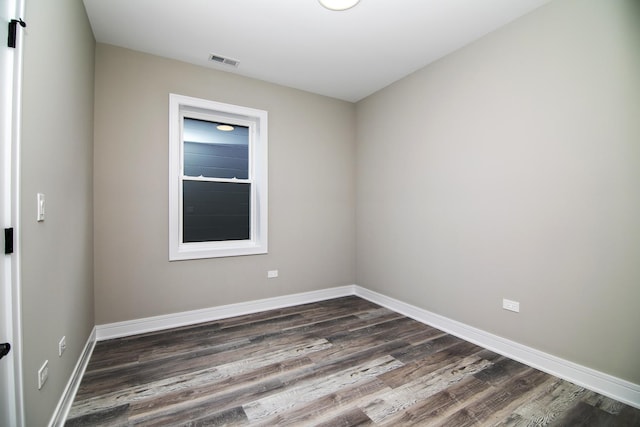 empty room with dark wood-type flooring