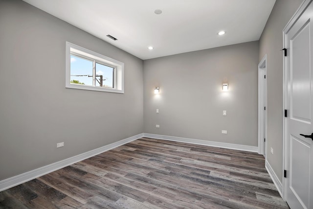 empty room with dark hardwood / wood-style floors