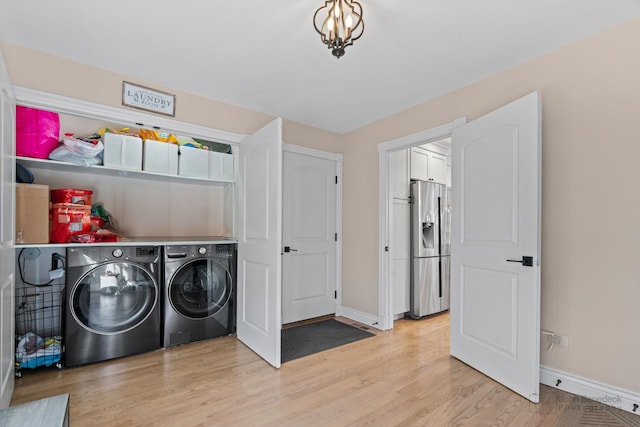 laundry area featuring light hardwood / wood-style floors and washing machine and dryer