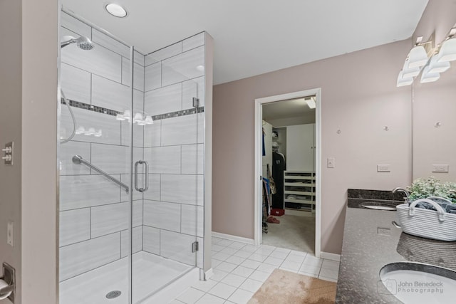 bathroom with tile patterned floors, an enclosed shower, and vanity