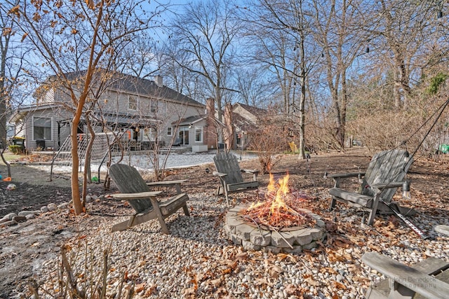 view of yard with an outdoor fire pit and a patio area