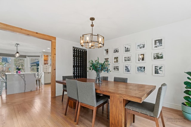 dining room featuring an inviting chandelier and light hardwood / wood-style flooring