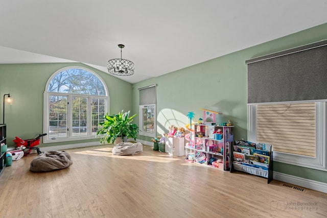 rec room featuring lofted ceiling and light hardwood / wood-style flooring