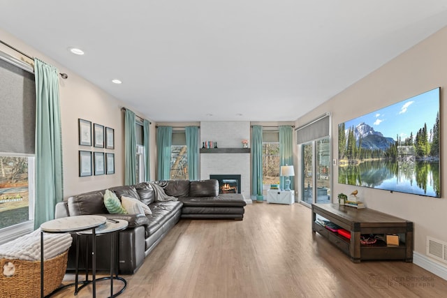 living room featuring a fireplace and light hardwood / wood-style floors