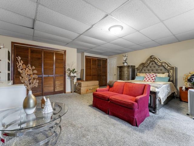 bedroom featuring a paneled ceiling and carpet