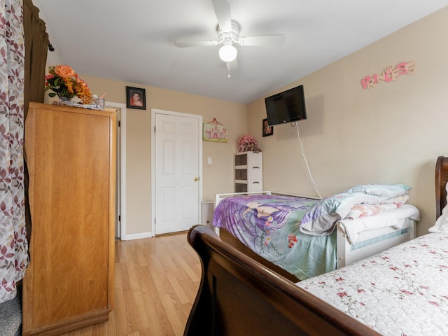 bedroom with light hardwood / wood-style floors and ceiling fan