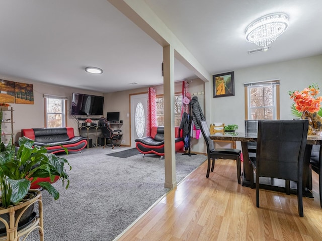 game room with light carpet, plenty of natural light, and an inviting chandelier