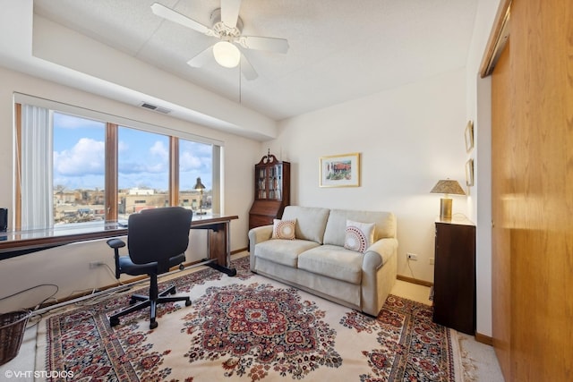 carpeted office featuring ceiling fan