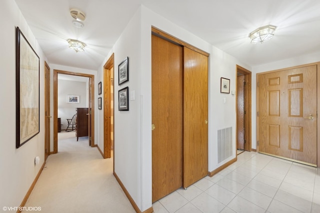 hall featuring light tile patterned flooring