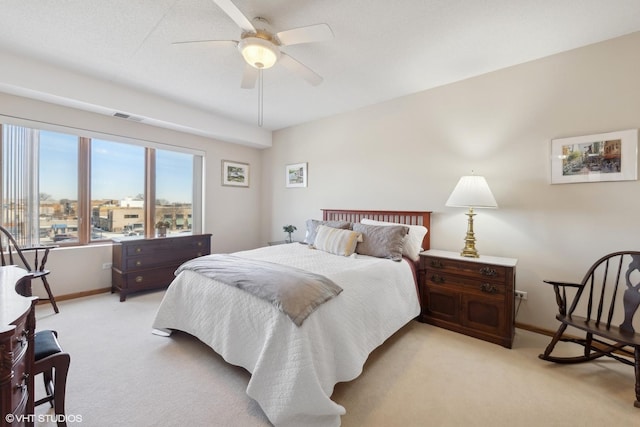 bedroom featuring light colored carpet and ceiling fan