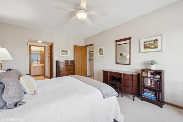 carpeted bedroom featuring connected bathroom and ceiling fan