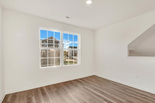 empty room with hardwood / wood-style floors