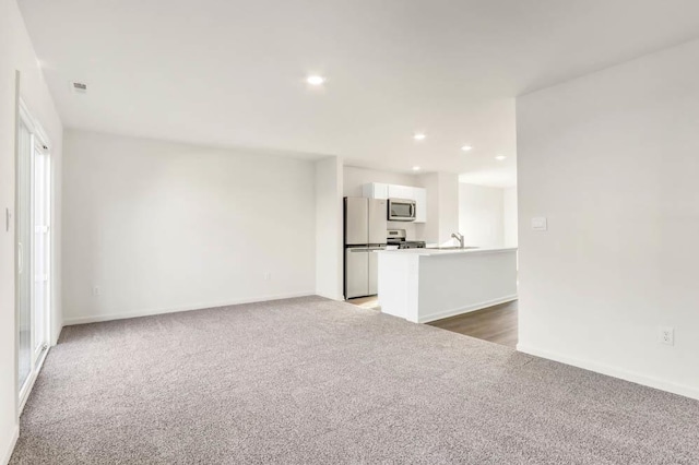 unfurnished living room with dark colored carpet