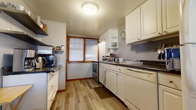 kitchen with sink, white cabinets, white appliances, and light hardwood / wood-style floors