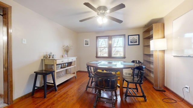 dining area with wood-type flooring and ceiling fan