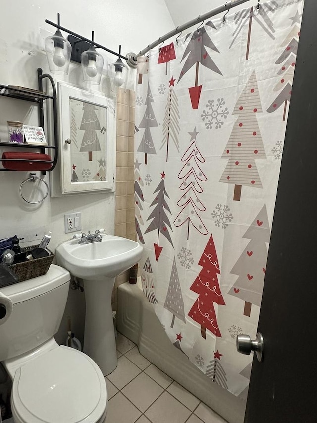 bathroom with shower / tub combo, tile patterned floors, and toilet