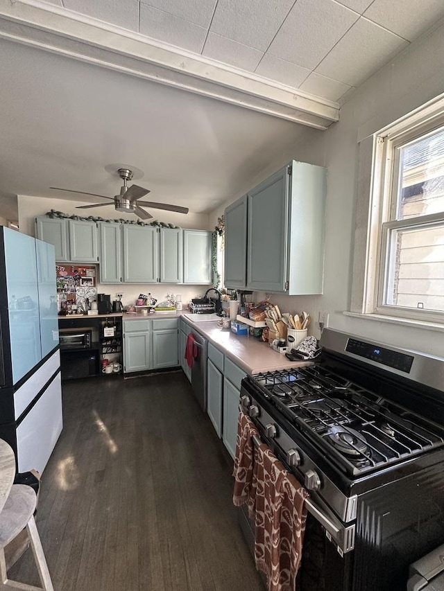 kitchen featuring sink, appliances with stainless steel finishes, dark hardwood / wood-style floors, beamed ceiling, and ceiling fan