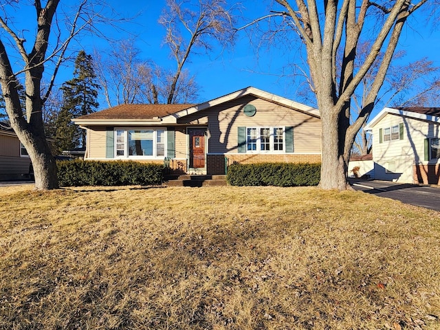 ranch-style home with a front lawn