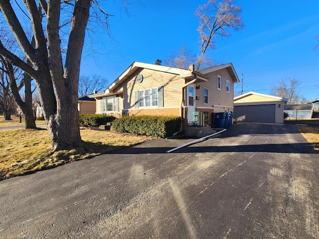 view of front of home with a garage and an outdoor structure