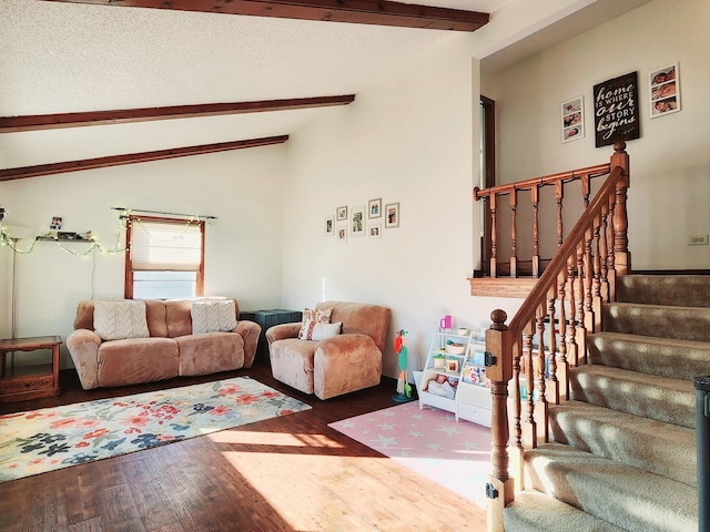 living room with hardwood / wood-style flooring, vaulted ceiling with beams, and a textured ceiling