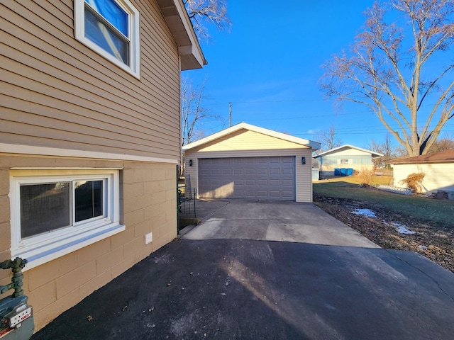 view of side of property featuring a garage and an outbuilding