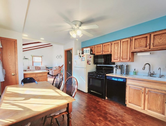 kitchen featuring sink, dark wood-type flooring, black appliances, and ceiling fan