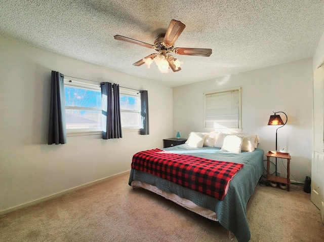 carpeted bedroom with ceiling fan and a textured ceiling