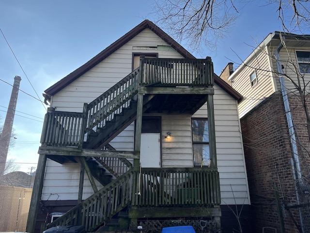 back of property featuring a balcony