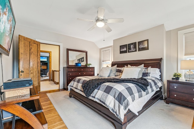 bedroom featuring vaulted ceiling, ceiling fan, and light hardwood / wood-style flooring