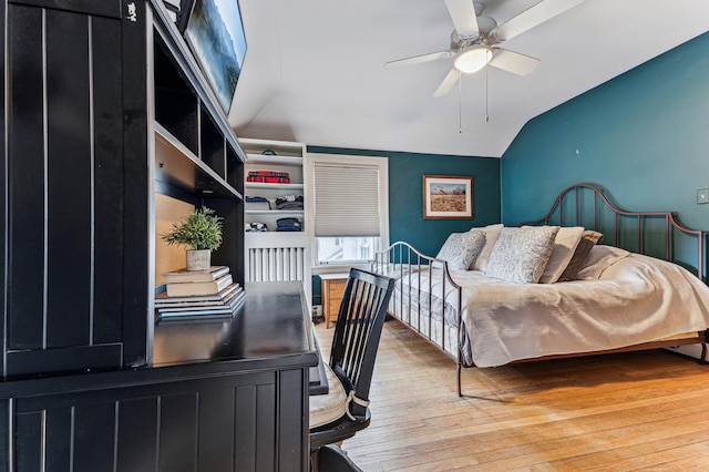 bedroom featuring vaulted ceiling and wood-type flooring