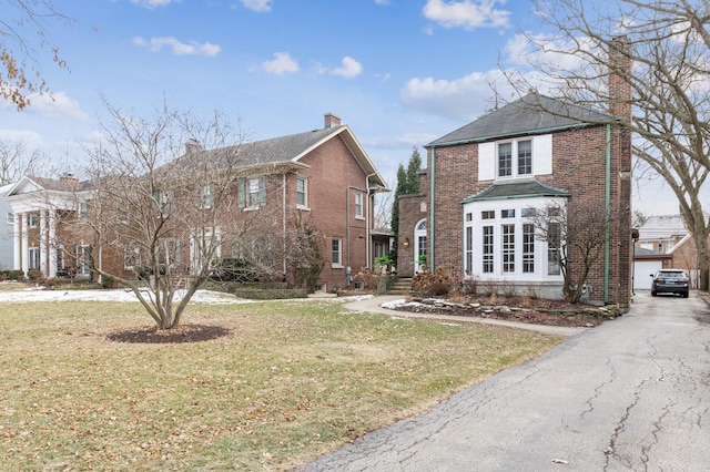 view of front property featuring a garage and a front yard