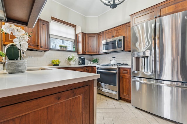 kitchen featuring light tile patterned flooring, ornamental molding, stainless steel appliances, and decorative backsplash