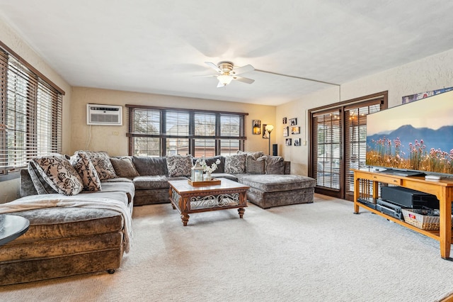 carpeted living room featuring ceiling fan and a wall mounted air conditioner