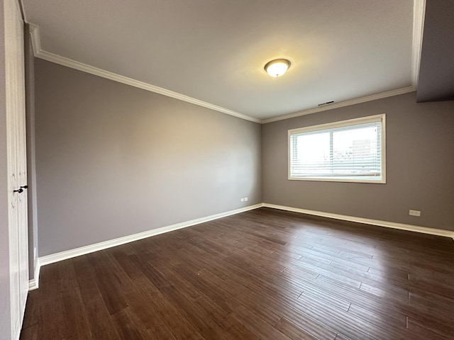 empty room with ornamental molding and dark hardwood / wood-style floors