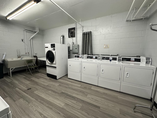 laundry area with separate washer and dryer, hardwood / wood-style floors, electric panel, and sink