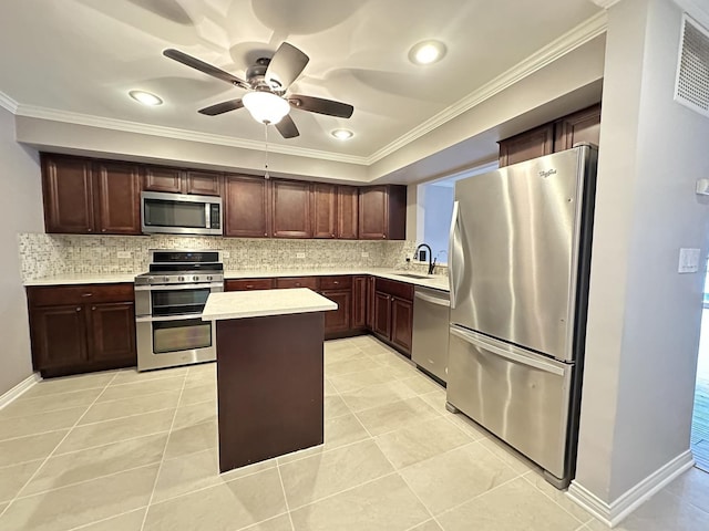 kitchen featuring sink, light tile patterned floors, dark brown cabinets, stainless steel appliances, and a kitchen island