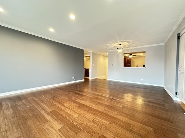 spare room with ceiling fan, ornamental molding, and hardwood / wood-style floors