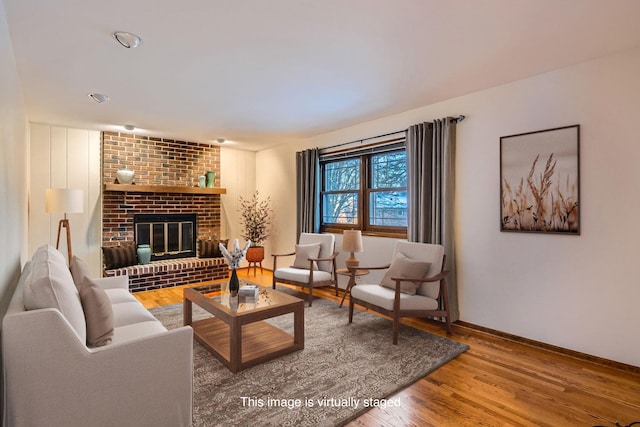 living room with a fireplace and wood-type flooring