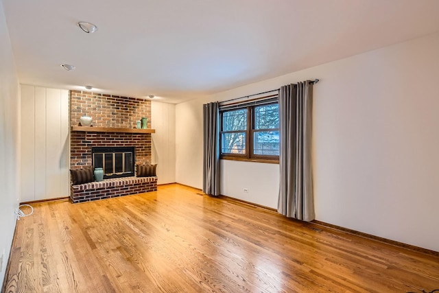 unfurnished living room featuring a fireplace and wood-type flooring