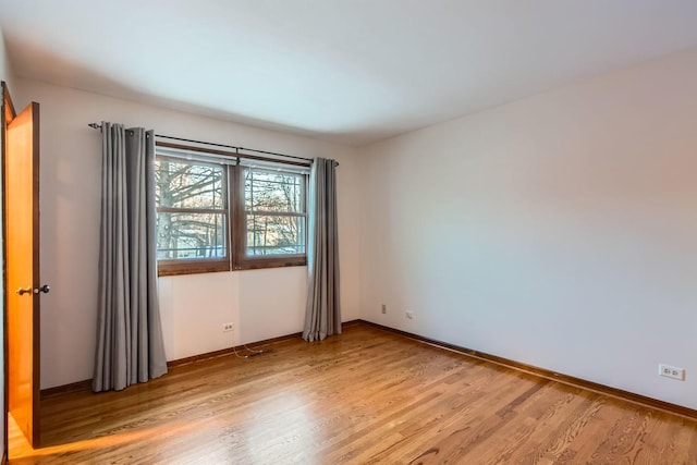 spare room with light wood-type flooring