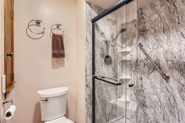 bathroom with an enclosed shower and toilet