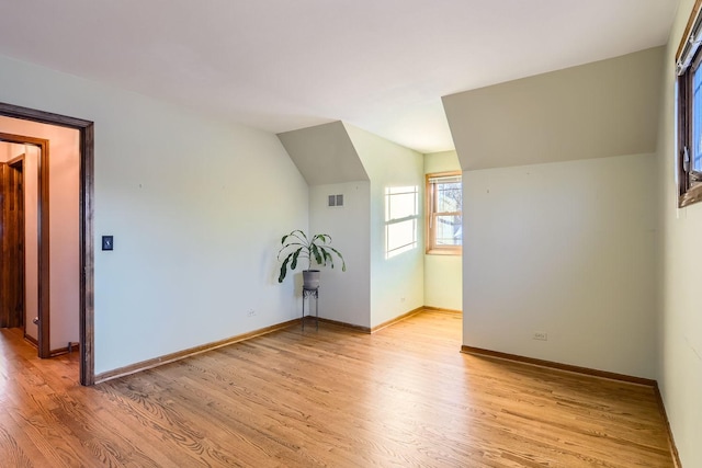 empty room with lofted ceiling and light wood-type flooring