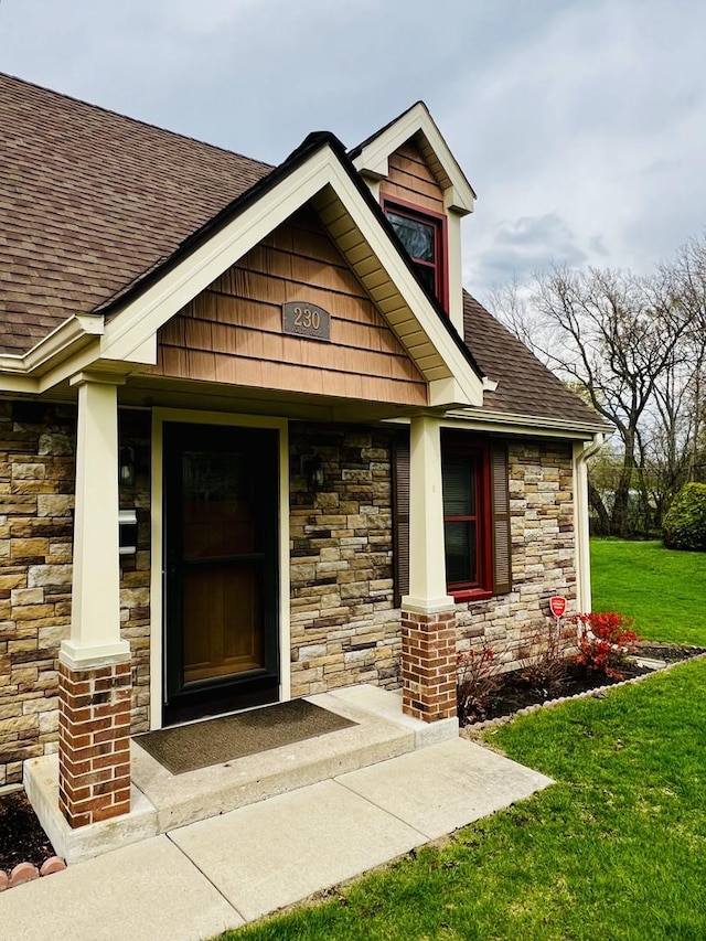 230 N Forest Ct, Palatine, IL 60074 - doorway to property featuring stone siding, a lawn, a porch, and roof with shingles