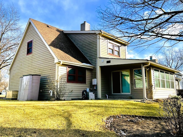 back of house with a lawn